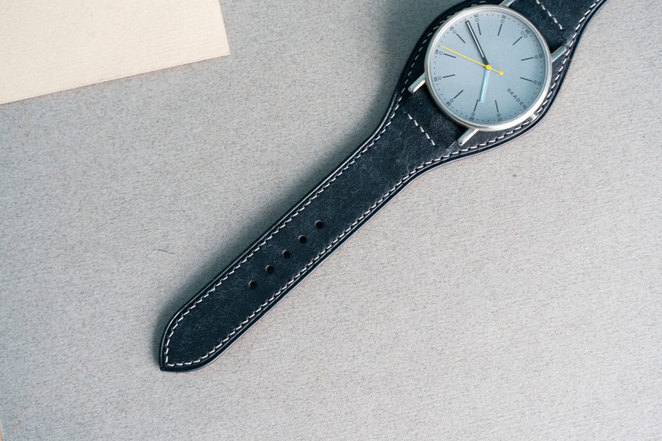 Close view of the pale watch face on the black Bund strap.