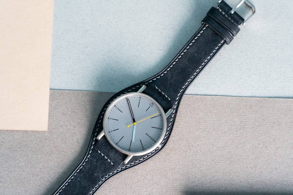 Black leather around the watch case, with a light stitched outline.