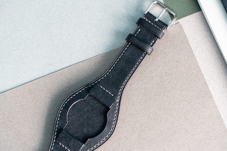 Black Bund strap without the watch, showing its central pad and attachments.