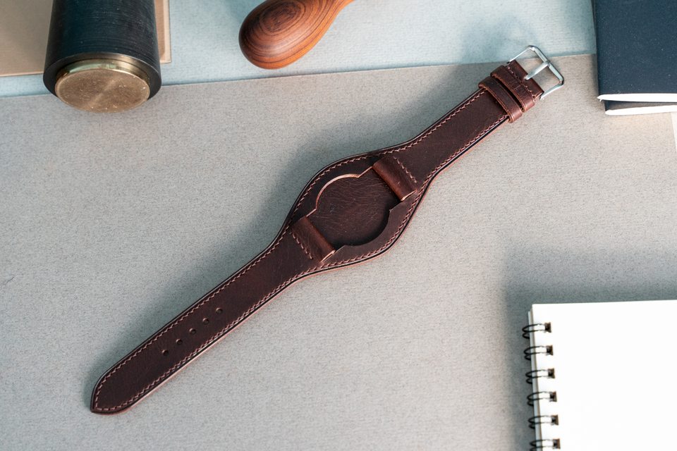 Dark brown Bund strap laid flat with its watch removed.