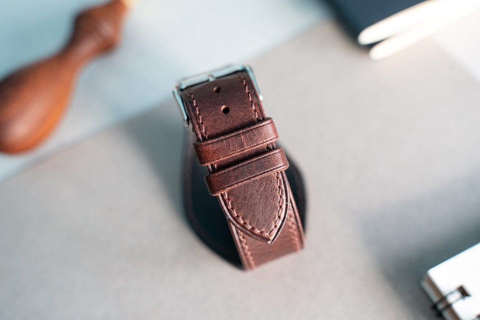 Dark brown Bund strap fastened into a loop, seen from the buckle side.