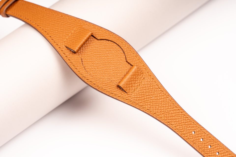 Close view of the honey Bund centre and folded leather attachments.