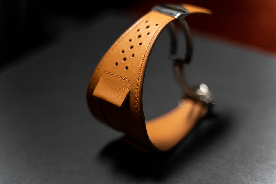 Side view of the perforated tan Bund design curved into a loop.