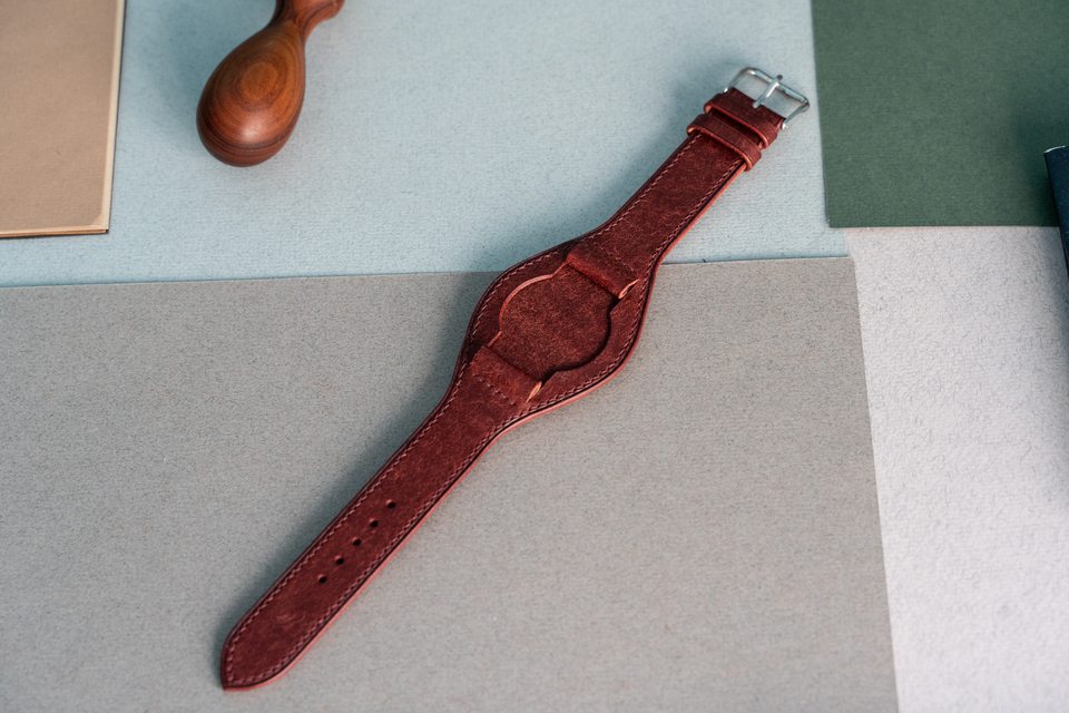 Red Bund strap without its watch, with the shaped central pad exposed.