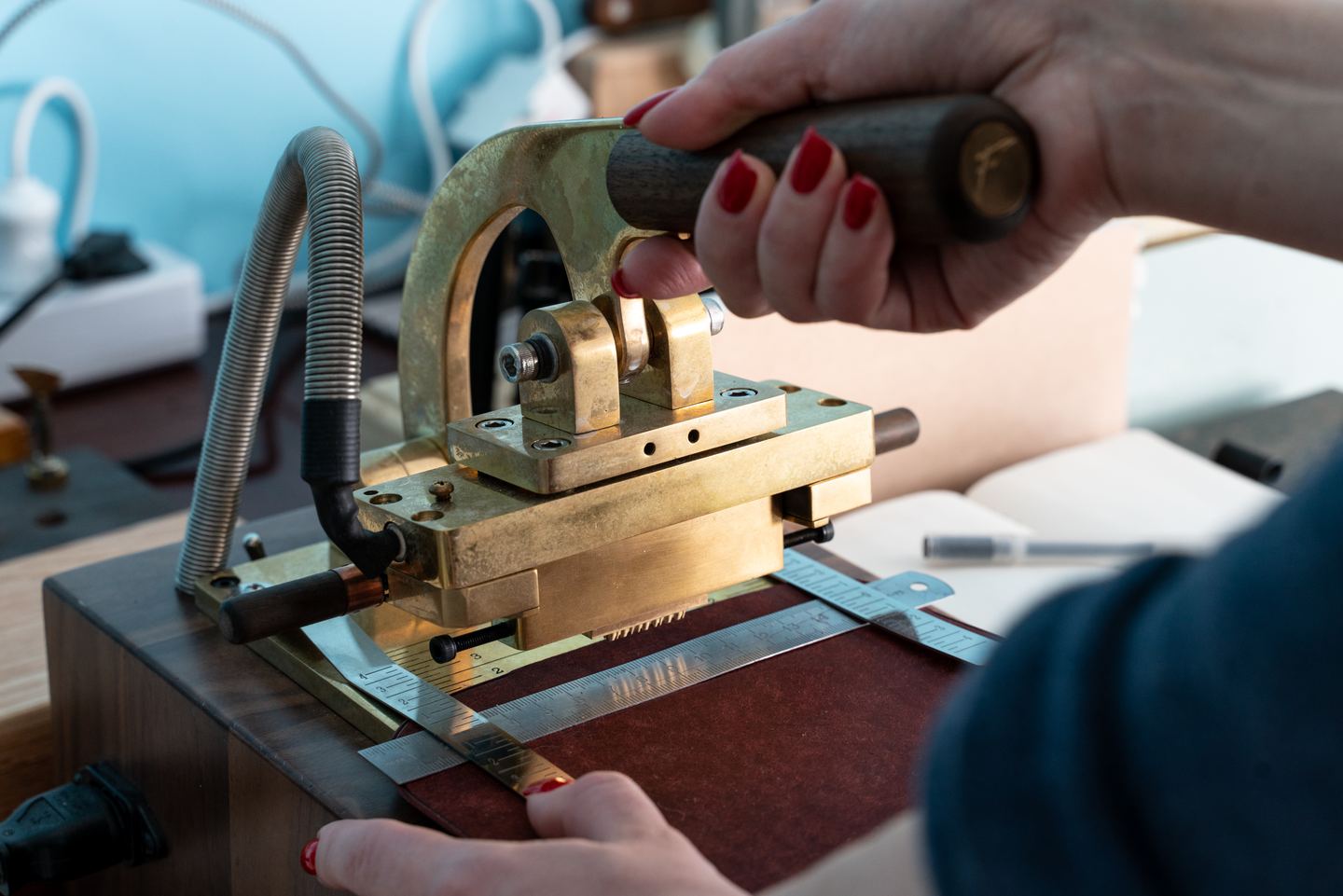 Hands cutting a pad on the clicker press