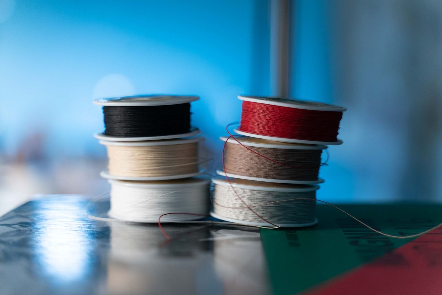 Spools of waxed thread on the bench